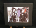Beach Hut Goths — limited edition giclée print, two goth women by Brighton beach huts in black and violet, 255x305mm