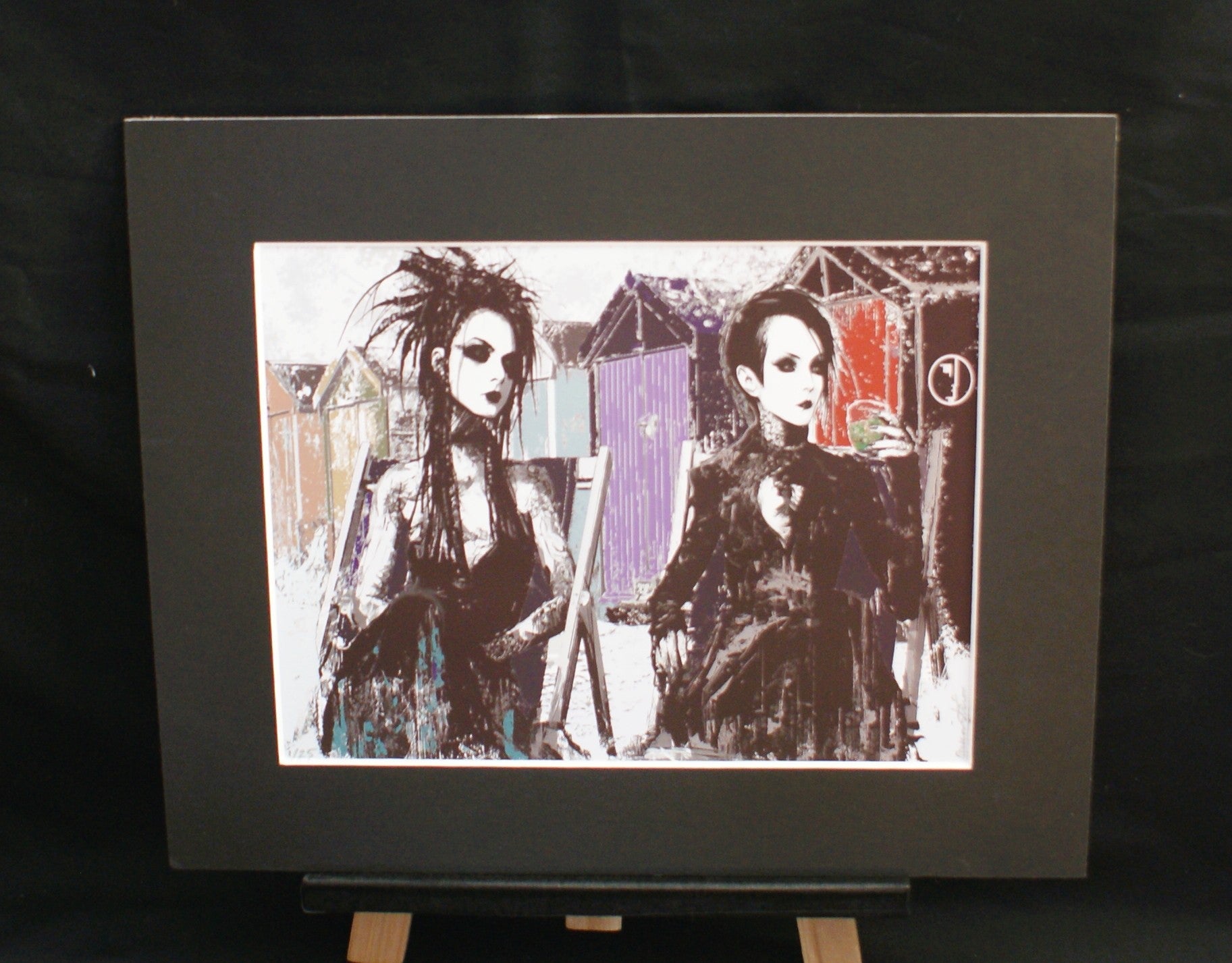 Beach Hut Goths — limited edition giclée print, two goth women by Brighton beach huts in black and violet, 255x305mm